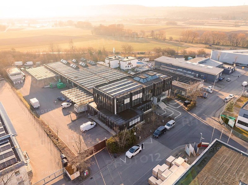Industrial complex with solar systems on the roofs, surrounded by rural landscape, Bauhof, Nufringen, Germany