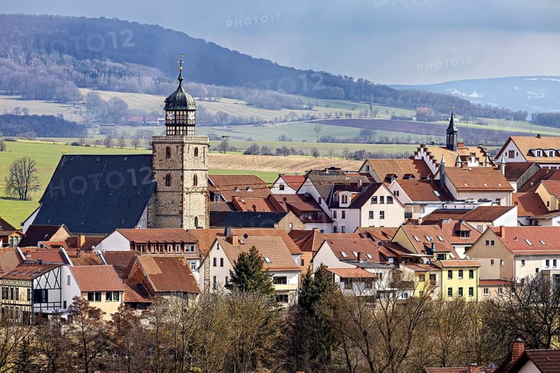 Historic town with characteristic tower and red roofs, surrounded by hills, the skyline of Geisa in the Rhön in Thuringia