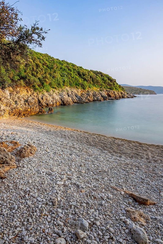 Crystal clear and turquoise water on the beach of Ustrine Bay on a sunny day at sunset on the island of Cres, long exposure, Croatia