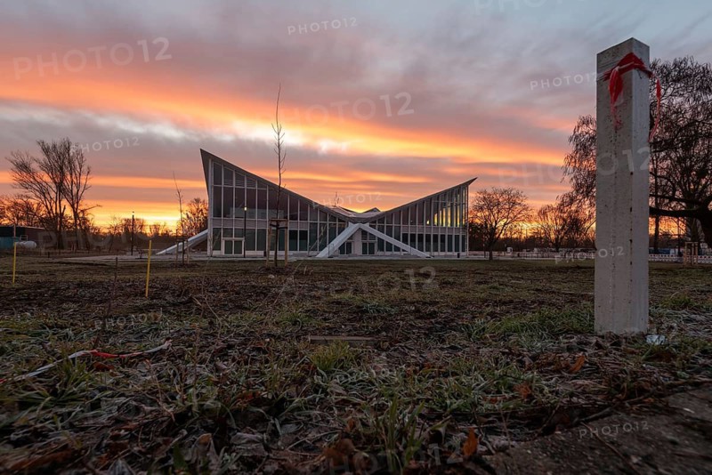 Hyparschale, heritage-protected building with striking roof construction in front of a dramatic sunset, Magdeburg, Saxony-Anhalt, Germany