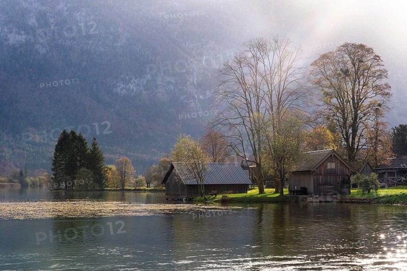 Lake Hallstatt near Steeg. Some boathouses. Autumn, backlight. Lake Hallstatt, Salzkammergut, Upper Austria, Austria