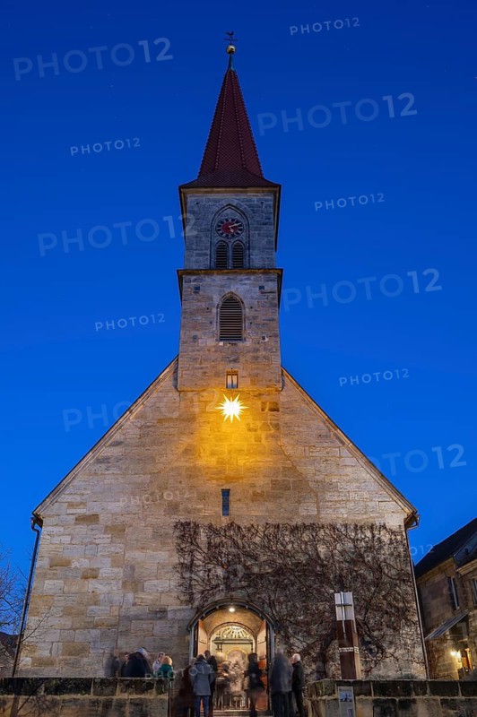 St Bartholomew's Church with poinsettia at dusk, Eschenau, Middle Franconia, Bavaria, Germany