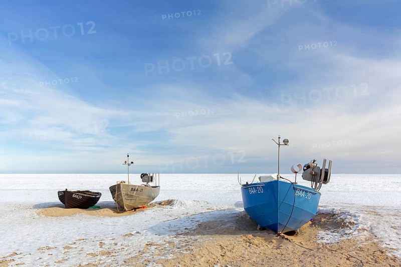 Fishing boats on snow covered beach in winter along the Baltic Sea at Baabe, Mönchgut peninsula, Island Rügen, Mecklenburg Western Pomerania, Germany