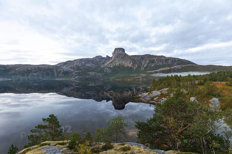 Magical morning fog on Steigtindvatnet in front of the majestic Steigtinden in Norway near Bodø