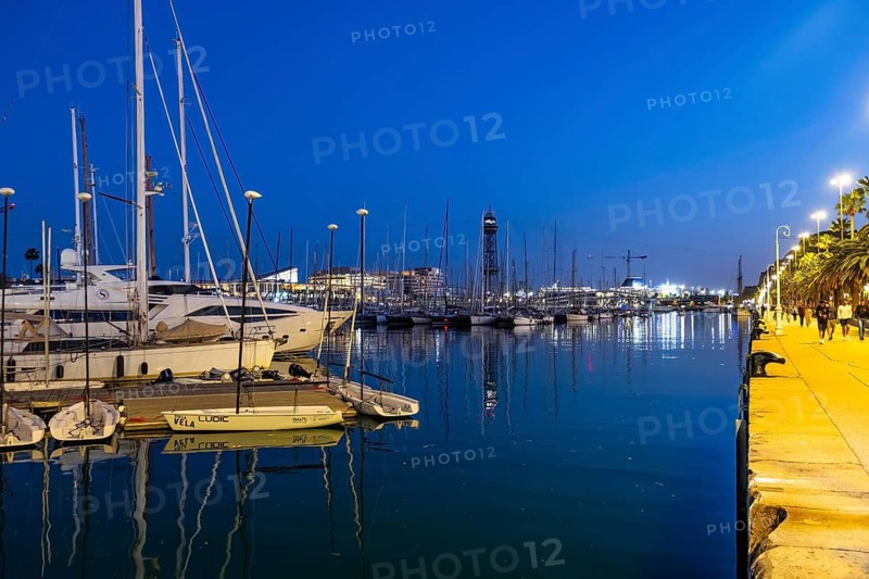 Night shot of the old harbour with boats in Barcelona, Spain