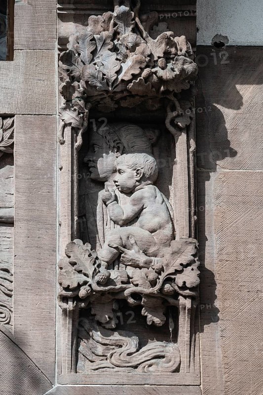 Historical relief, façade section, stone carving depicting a mother and child with floral framing in the historic old town of Constance, district of Constance, Baden-Württemberg, Germany