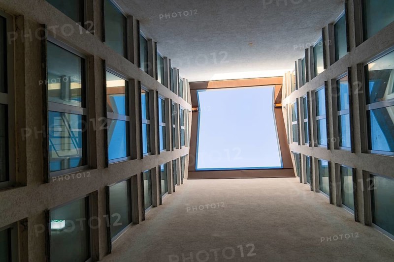 View upwards through a narrow courtyard with symmetrical windows and blue sky, Weil der Stadt, Böblingen district, Germany
