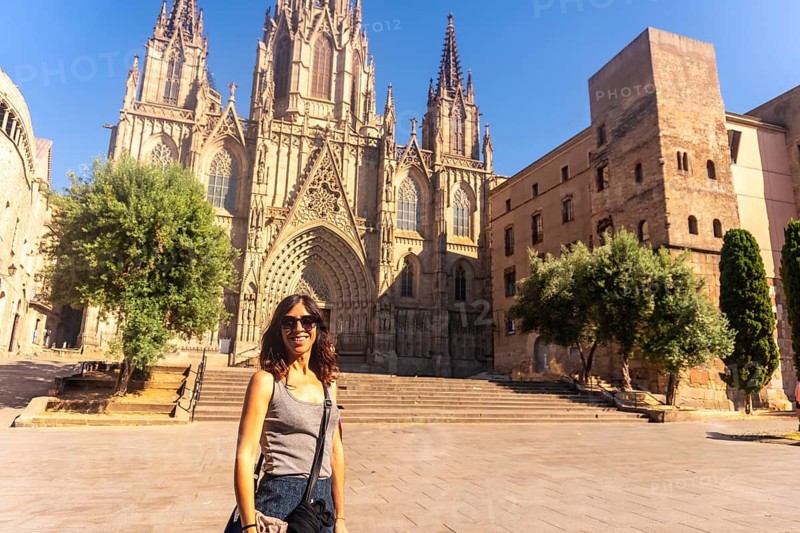 Tourist enjoying a sunny day in front of the cathedral of the holy cross and saint eulalia in barcelona, catalonia, spain