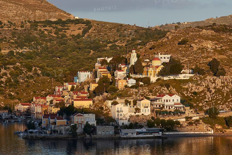 Urban views of a mountain village under warm morning lights with architectural charm, Symi Town, Symi, Dodecanese, Greek Islands, Greece