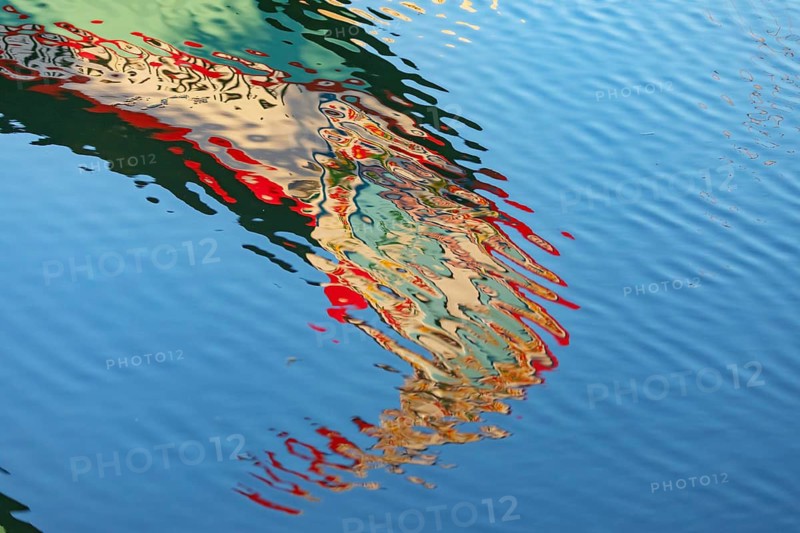 Traditional Moliceiro boat reflected in the water, Aveiro, Portugal