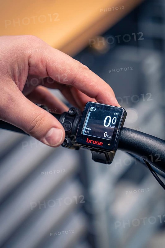 Digital display of a bike computer is operated by one hand on the handlebars, focus on technology, Waldbike Manufaktur, bicycle workshop, Calw, district of Calw, Black Forest, Germany