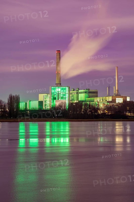 The Lausward combined heat and power plant in Düsseldorf, gas and steam turbine power plant, operated by Stadtwerke Düsseldorf and EnBW, on the Rhine, green illuminated city window, the chimney of the Fortuna power plant unit, the power plant generates electricity, also traction current and district heating, North Rhine-Westphalia, Germany