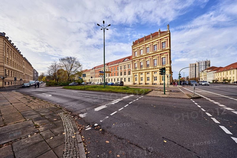 Historic residential building, architect Georg Christian Unger, historic town house, façade with windows, lantern, street, sidewalk, pedestrian traffic light, pedestrian crossing, cycle path, central island, meadow, trees, blue sky, cumulus clouds, intersection Breite Straße with Dortustraße, Potsdam, state capital, district-free city, Brandenburg, Germany