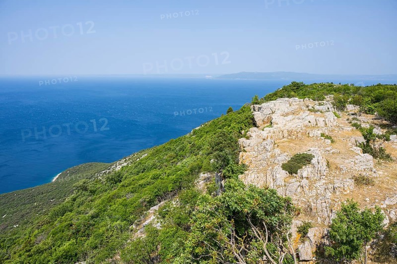 View from Lubenice across the sea with coastal landscape and bays on a sunny day on the island of Cres, Croatia
