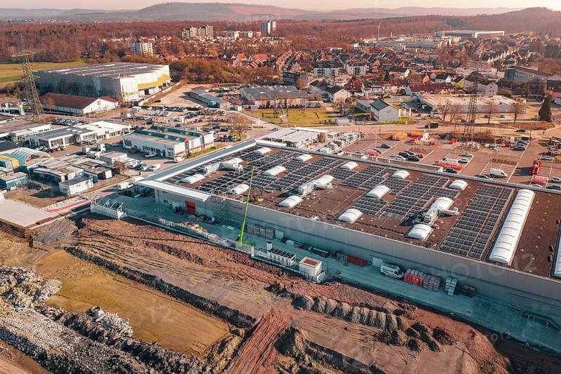 Industrial complex with solar systems and parking spaces in an urban autumn landscape, PV Bau Auf OBI Bau Markt, Mühlacker, Enzkreis, Germany
