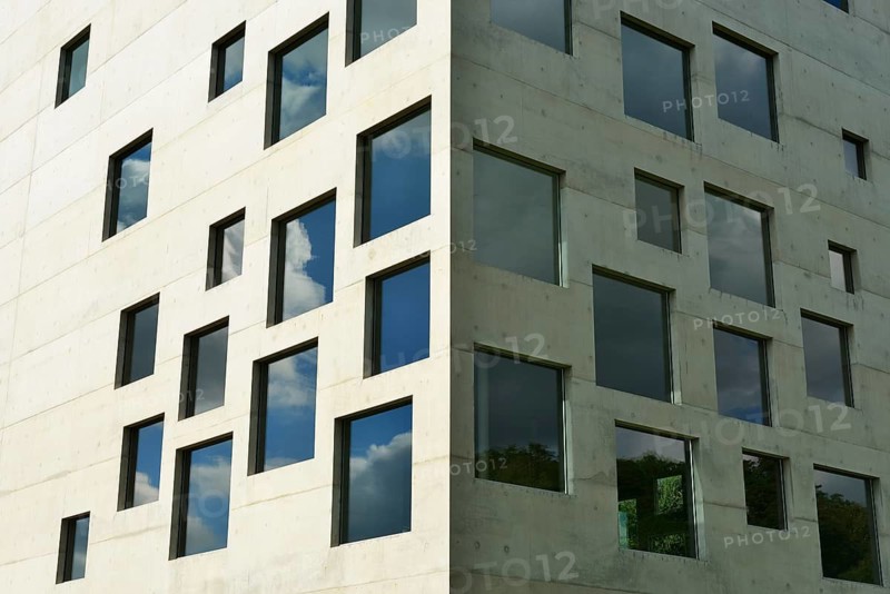 A modern building with numerous square windows in front of a blue sky with clouds, School of Management and Design, Zeche Zollverein, Essen, Ruhr Area, North Rhine-Westphalia, Germany
