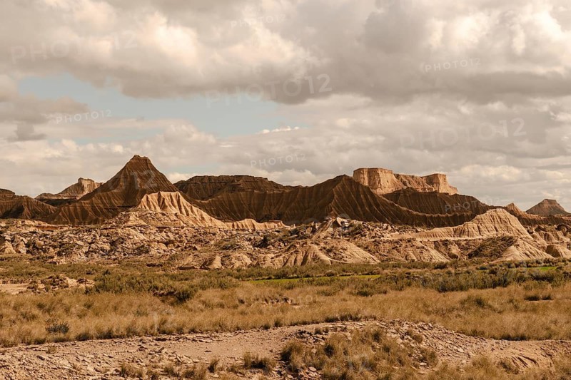 Eroded mountains and dry vegetation are creating an otherworldly landscape in the bardenas reales desert, navarre, spain