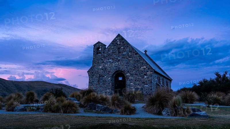 The small church The Church of the Good Shepherd on Lake Tekapo with a cloudy sky at sunset. Canterbury, South Island, New Zealand