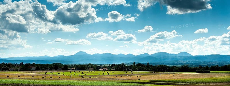 View of the Chain of Volcanoes and Limagne plain under a vibrant sky in Puy-de-Dôme, Auvergne-Rhône-Alpes, France