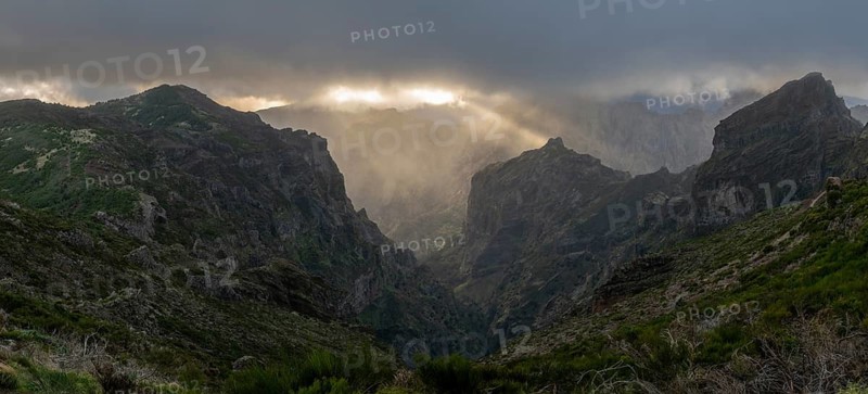 Sunset at Pico do Arieiro, sun shining through clouds, sunbeam, hiking trail PR1, Madeira, Portugal