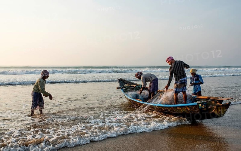 Sorting fishing nets after returning from fishing, Bay of Bengal (Odisha, India)