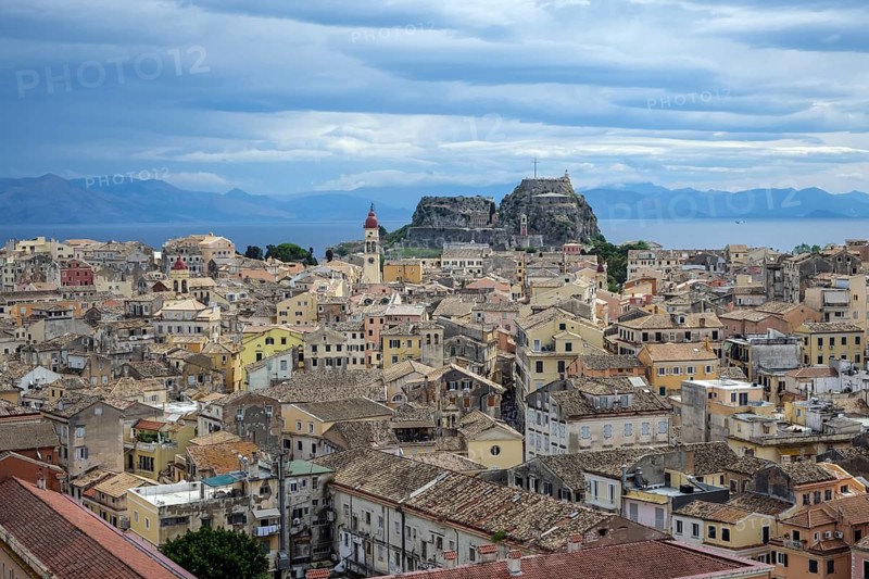Corfu Town, Corfu, Greece, City overview Corfu Town with the Greek Orthodox Church of Agios Spiridon and the New Fortress. Back mainland Albania