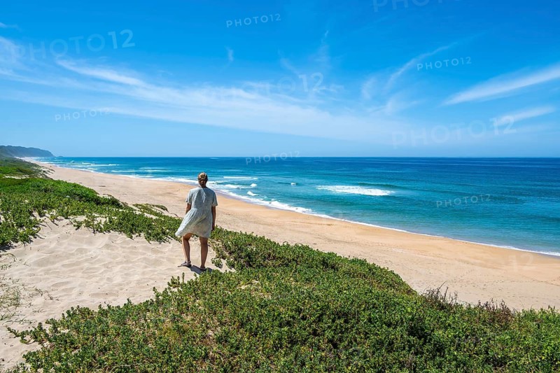 Young tourist on sandy, ocean and sandy beach, Kleinkrantz Beach, Wilderness, South Africa