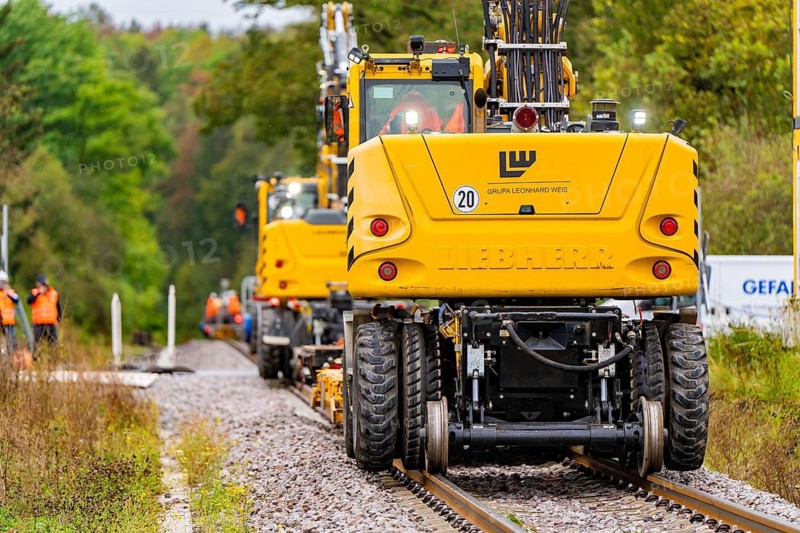 Several yellow vehicles working on a railway line, surrounded by nature, track construction Hermann Hesse Bahn, district of Calw, Black Forest, Germany