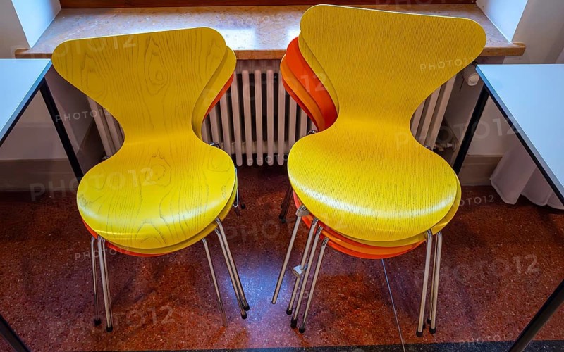 Colourful wooden chairs in the sixties style in a room in the Museum of Communication on Leipziger Straße in Berlin Mitte, Germany