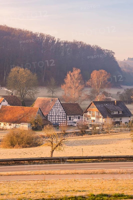 Village with half-timbered houses in a hilly, rural area in the morning, Gechingen, Calw district, Germany