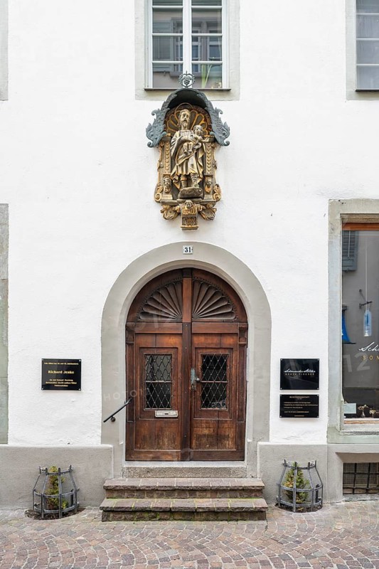 Wooden door with an elaborate sculpture above it at a town house in the historic old town of Constance, traditional craftsmanship, district of Constance, Baden-Württemberg, Germany