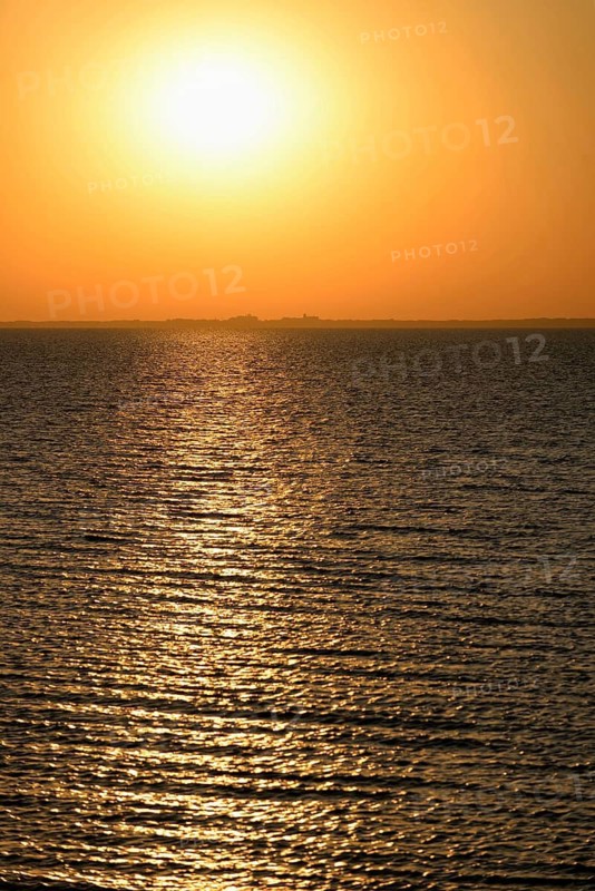 Sunset over the North Sea, on the horizon the contours of the island of Juist, Norddeich, Lower Saxony, Germany