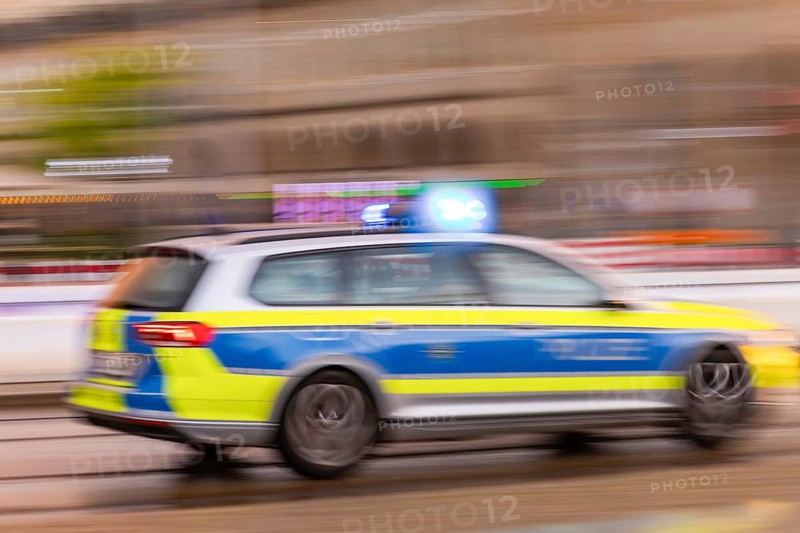 A police car on an emergency drive on Wilsdruffer Straße at Altmarkt with flashing blue lights, Dresden, Saxony, Germany