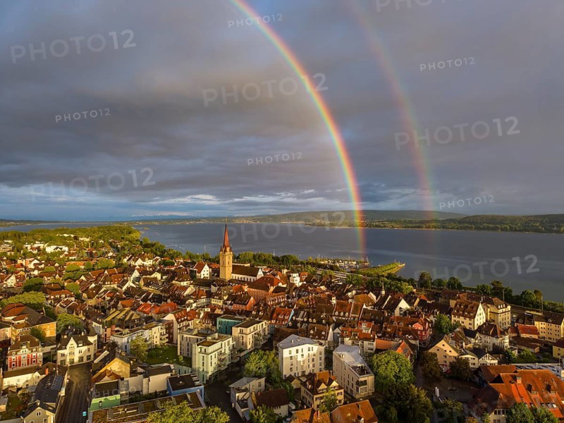 Aerial view of the historic old town of Radolfzell am Lake Constance with the cathedral illuminated by the evening sun, behind it a rainbow, district of Konstanz, Baden-Württemberg, Germany