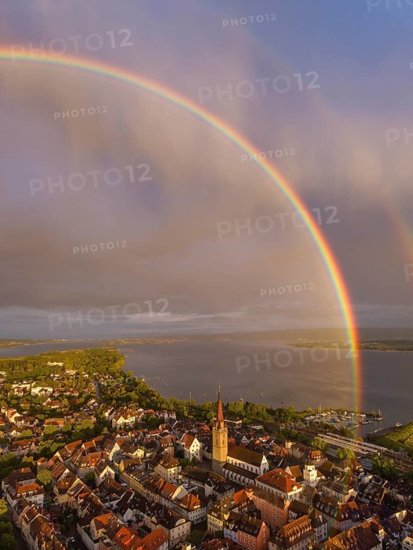 Aerial view of the historic old town of Radolfzell am Lake Constance with the cathedral illuminated by the evening sun, behind it a rainbow, district of Konstanz, Baden-Württemberg, Germany