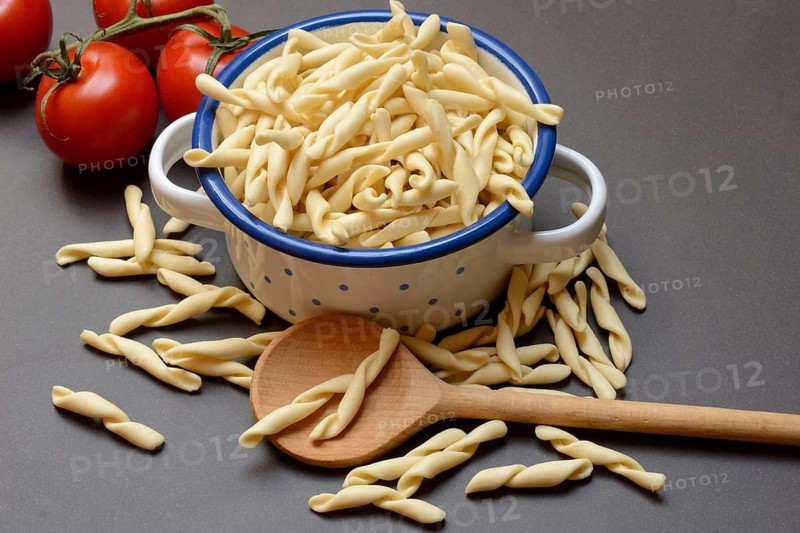 Uncooked strozzapreti, Italian type of pasta in pot
