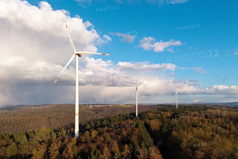 Three wind turbines above a lush forest under a blue sky with white clouds, wind turbine, near Schorndorf-Winterbach, Baden-Württemberg, Germany