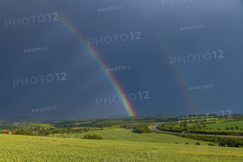 Thunderstorm cell with rainbow over fields near Krebs in the Osterzgebirge, Krebs, Saxony, Germany