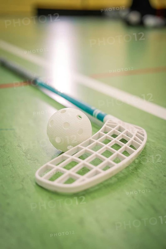 Close-up of a floorball racket with ball on a green indoor floor, foolball, Calw, Germany