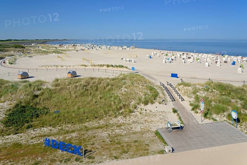 View over the dune landscape to the beach with beach chairs and areas for sports, blue sky, North Sea, Norddeich, Lower Saxony, Germany