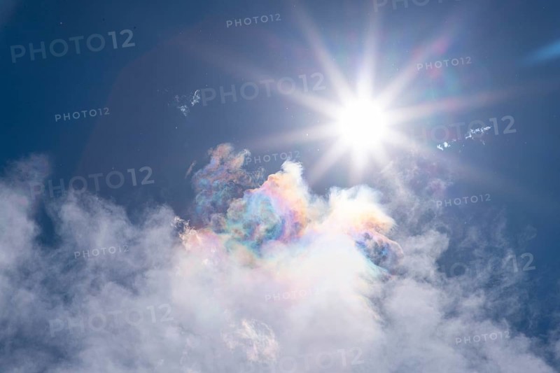 Brilliant sun over iridescent colorful clouds in the sky, Ternitz, Lower Austria, Austria