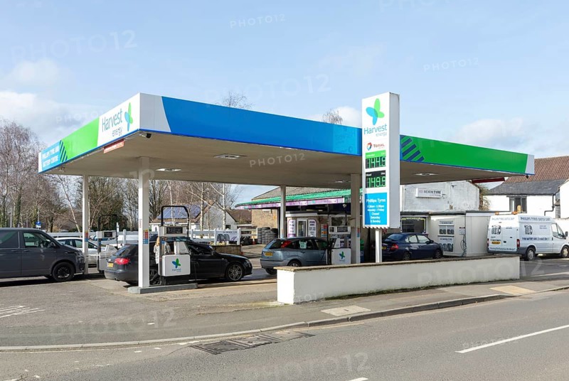 Petrol station forecourt Harvest Energy, Centre Garage, Castle Cary, Somerset, England, UK - comparatively high fuel prices displayed
