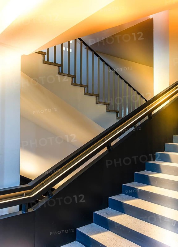 Carefully restored stairwell of the West Head Tower with newly developed steel staircase, which was installed hanging over the existing stairs while maintaining the old monumental staircase, former Tempelhof airport, Berlin, Germany