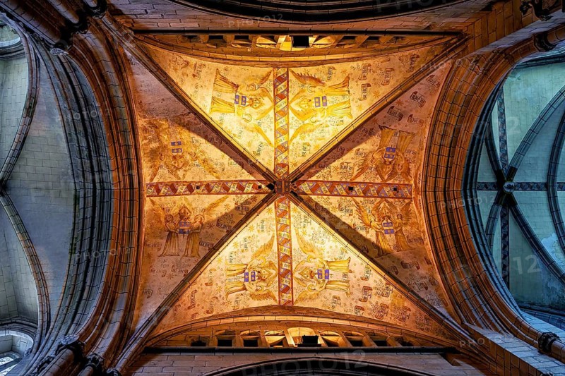 Gothic vault with ornately decorated frescoes under warm light, Saint-Paul-Aurélien Cathedral in Saint-Pol-de-Léon, Brittany