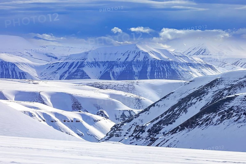 Snow covered mountains in Arctic landscape at Mohnbukta, bay at the western shore of Storfjorden in Sabine Land at Spitsbergen, Svalbard