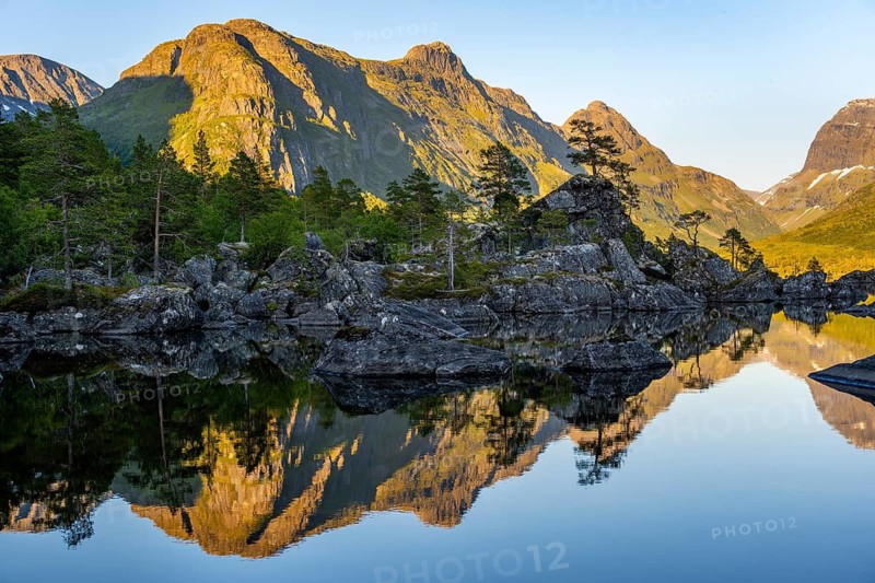 Picturesque mountain landscape with Innerdalstårnet peak in Innerdalen high valley, mountain peaks reflected in Lake Innerdalsvatna, Trollheimen Mountain Area, Sunndal, Møre og Romsdal, Norway