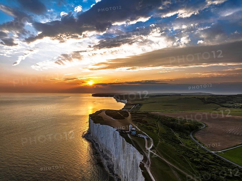 Sunset over Belle Tout Lighthouse from a drone, English Channel, Beachy Head Cliffs, East Sussex, England, United Kingdom