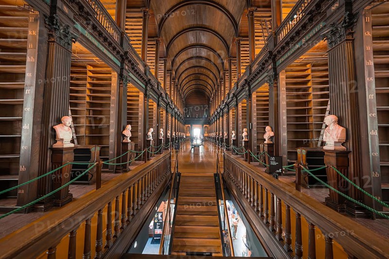 Symmetrical library with wooden galleries and classic busts, Trinity Collage, Dublin, Ireland