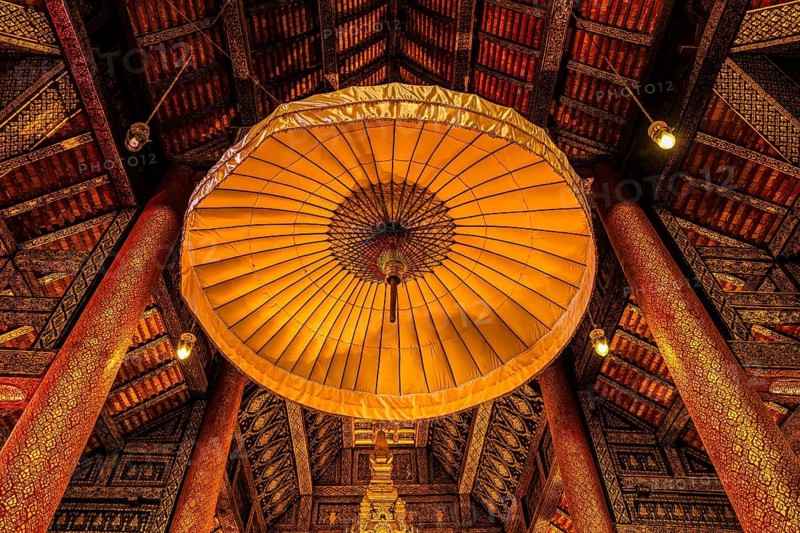 Artfully decorated interior with traditional parasol under richly decorated wooden roof construction, Buddhist temple complex Wat Phra That Si Chom Thong, near Chiang Mai, Chiang Mai Province, Thailand
