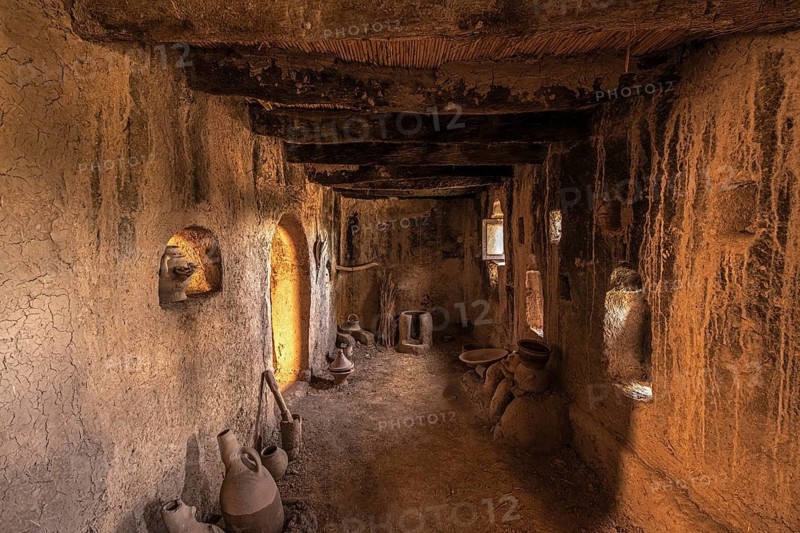 Interior of an old historic casbah with old clay jugs and fireplace, kasbah, clay castle, tighremt, Berber architecture, Maghreb, North Africa, Morocco